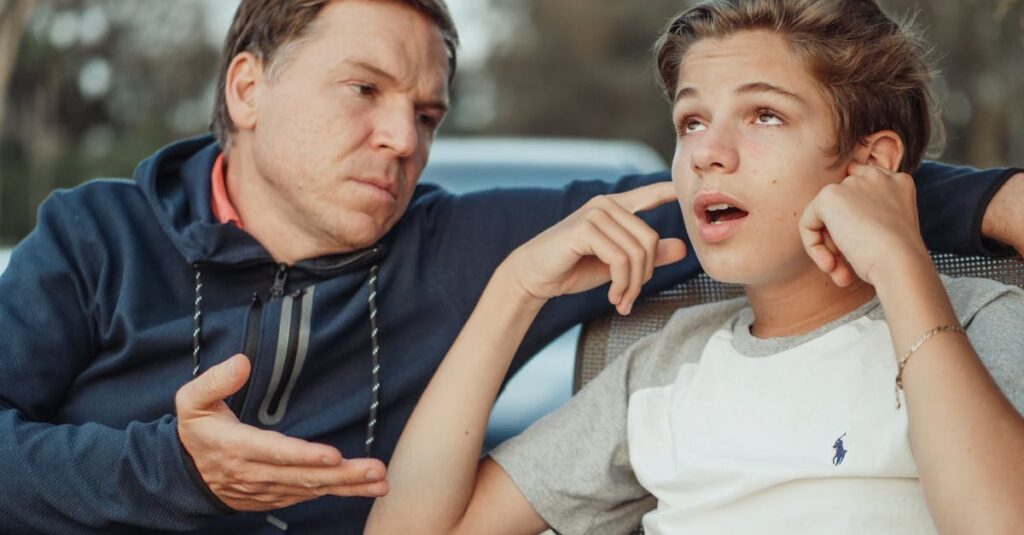 A father and teenage son having an intense conversation, capturing the essence of family dynamics and communication.