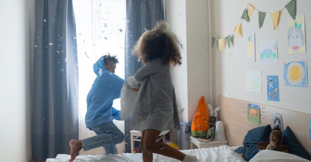 Two children having fun with a pillow fight in a cozy bedroom setting, creating a joyful and playful atmosphere.
