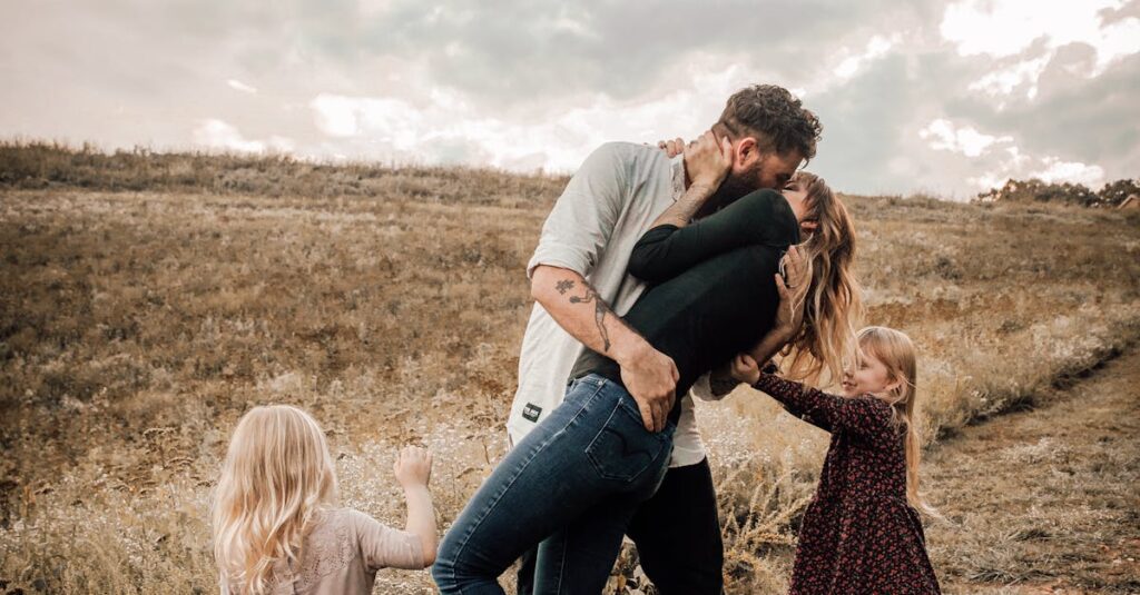 A joyful family shares a loving moment outdoors, surrounded by nature.