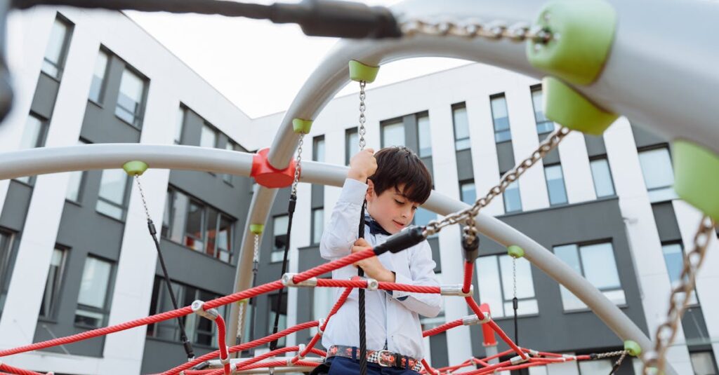 A boy in a white shirt climbing on a colorful jungle gym in an urban playground.