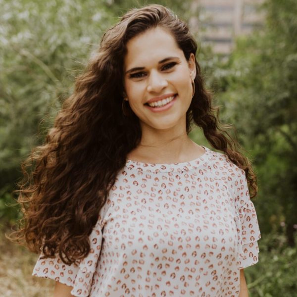 A woman with long hair and a smile.